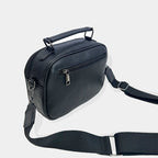 Bolso bandolera compacto negro de cuero con asa superior y correa ajustable