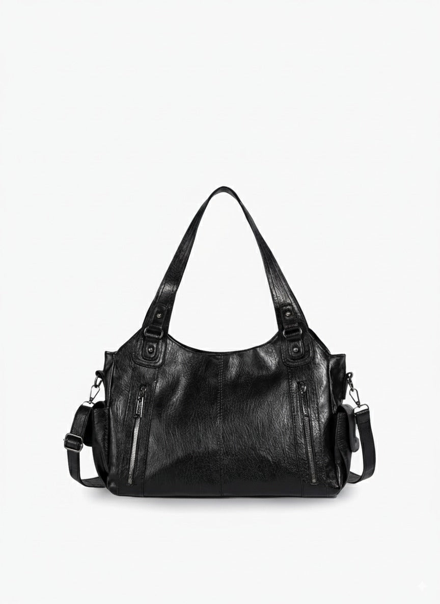 Bolso bandolera de piel sintética negro con asa doble y correas laterales, varios bolsillos.