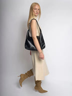 Bolso de cuero sintético negro tipo hobo con asa corta y correa ajustable