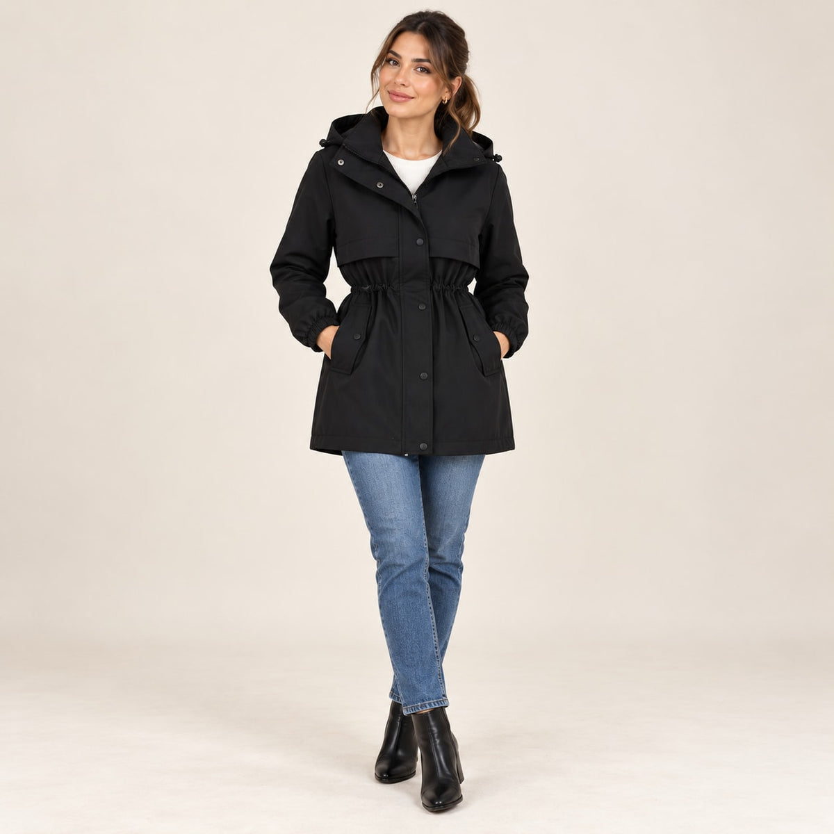 Parka negra con capucha, cintura entallada con cordón y bolsillos frontales con botones
